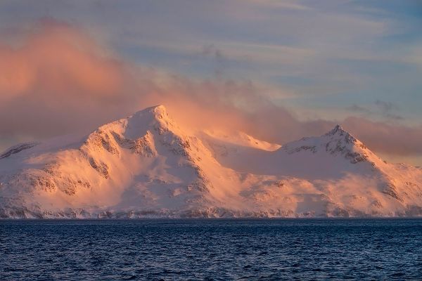 Antarctica-South Georgia Island-Bay of Isles Sunrise on mountain and ocean